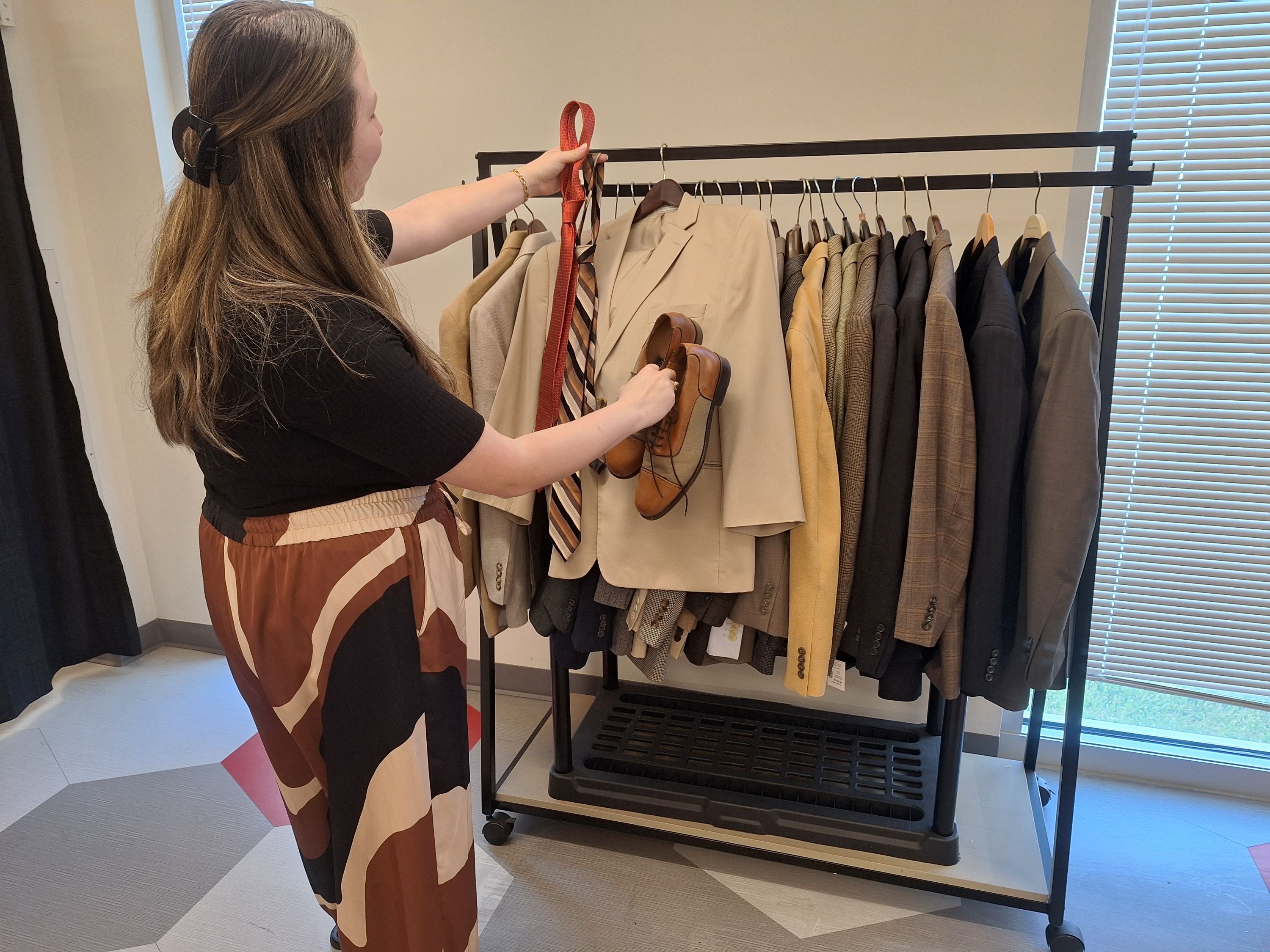 Madison Rosalez selects a tie to go with a suit and shoes.