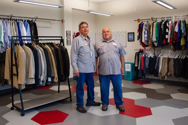 Maintenance technicians Trey Torres, left, and Bobby Casarez stand in the Career Closet's new location. 