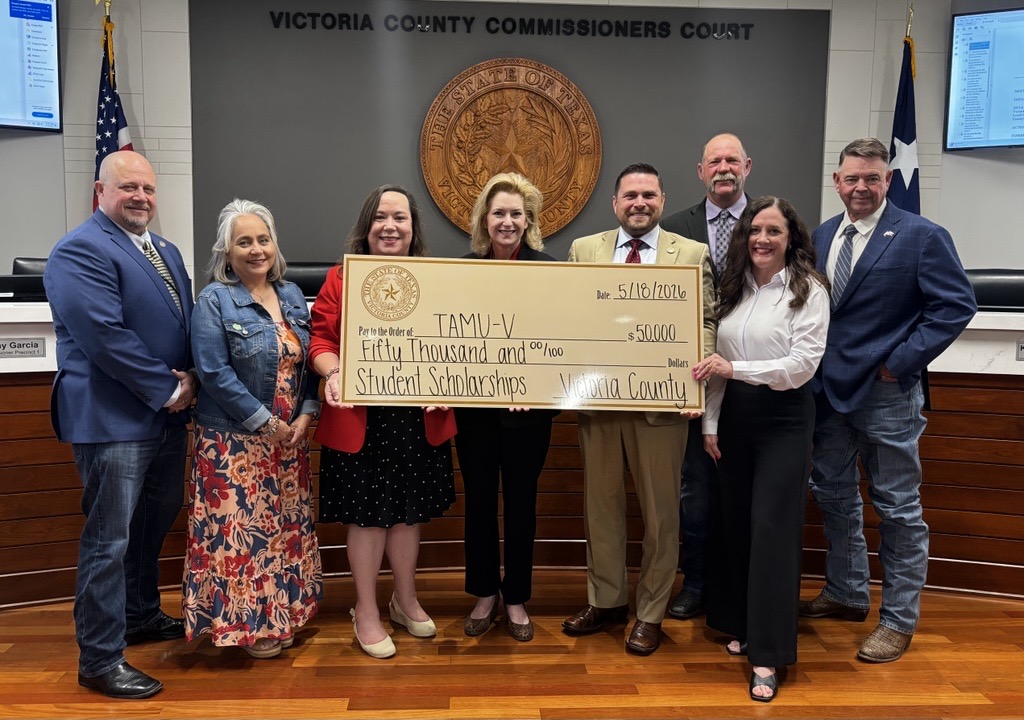 Representatives of Victoria County and Texas A&M University-Victoria pose for a picture with a big check.