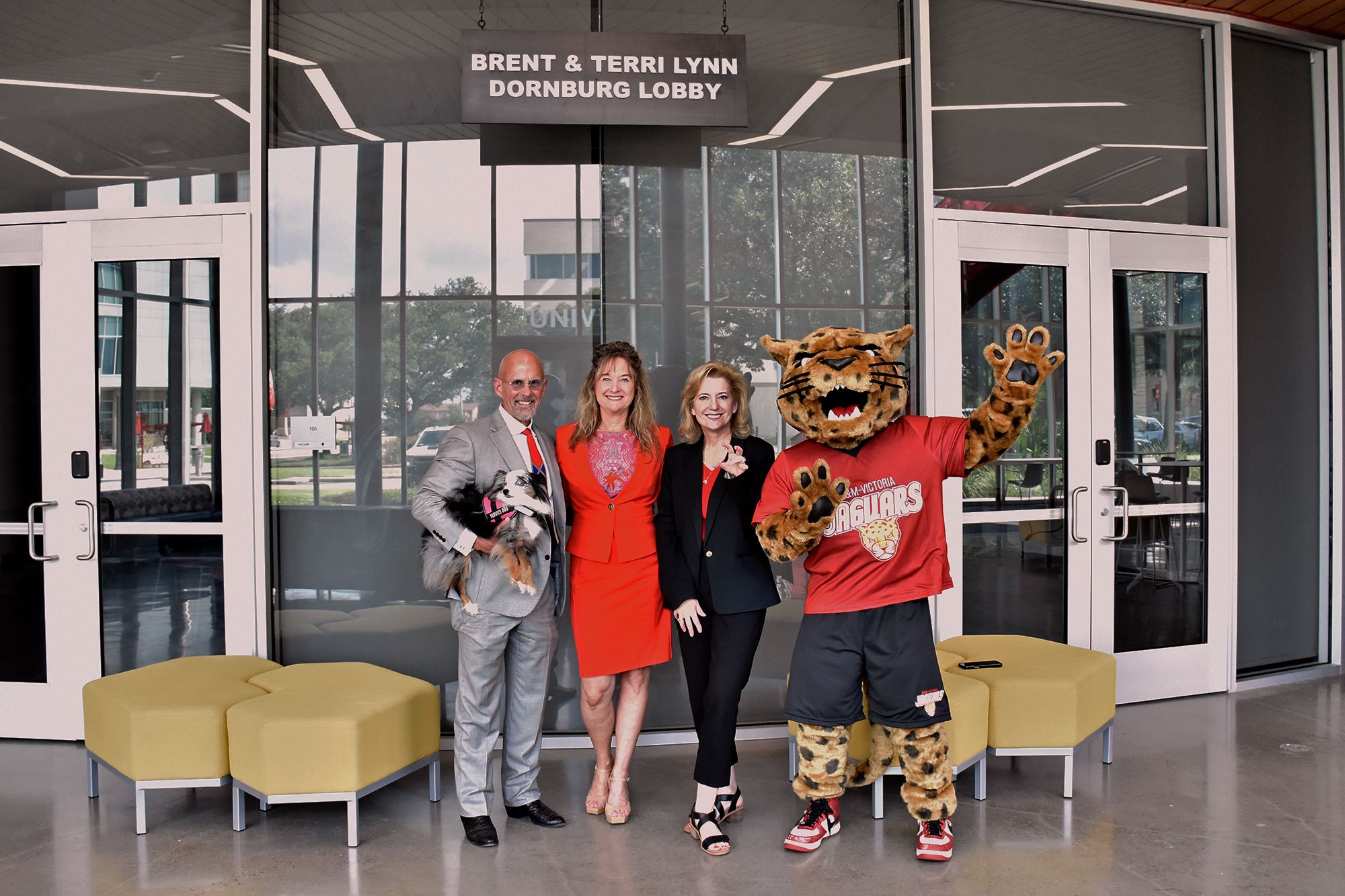 Brent and Terri Lynn Dornburg stand with A&M-Victoria President Christian Hardigree and jaX the Jaguar.