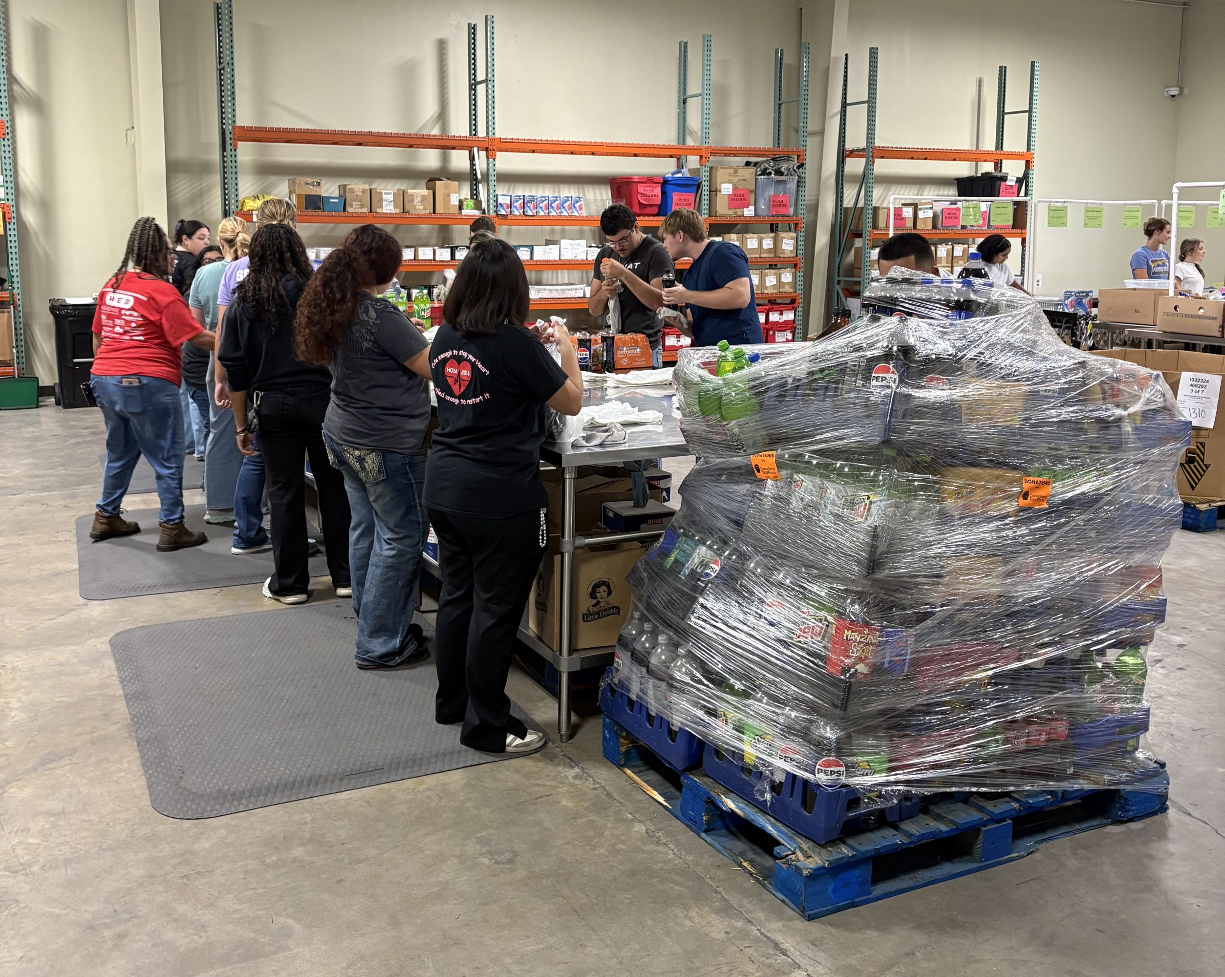 Students organize food inside the Food Bank warehouse.