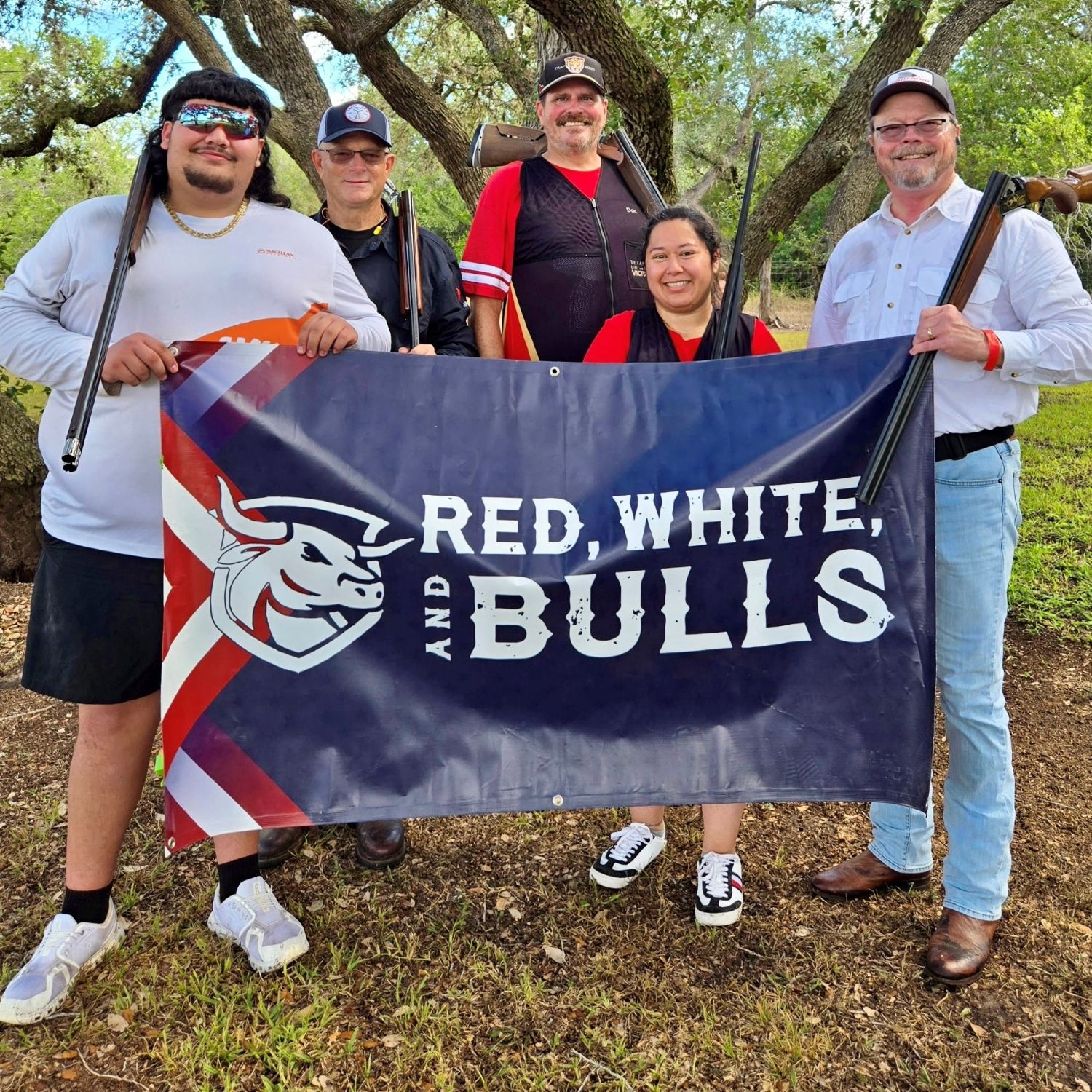 A team of competitors stand with a Red, White and Bulls banner.